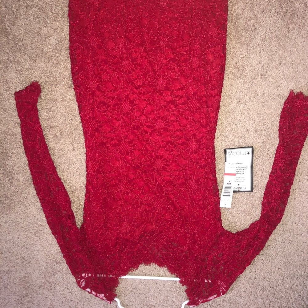 Red lacy dress, knee length, long sleeve.